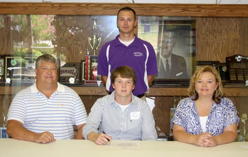 Chase Collomp with his parents Todd and Molly with Bethel Head Coach Rusty Thompson